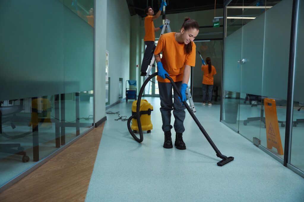 Cleaning company workers washing and cleansing the building